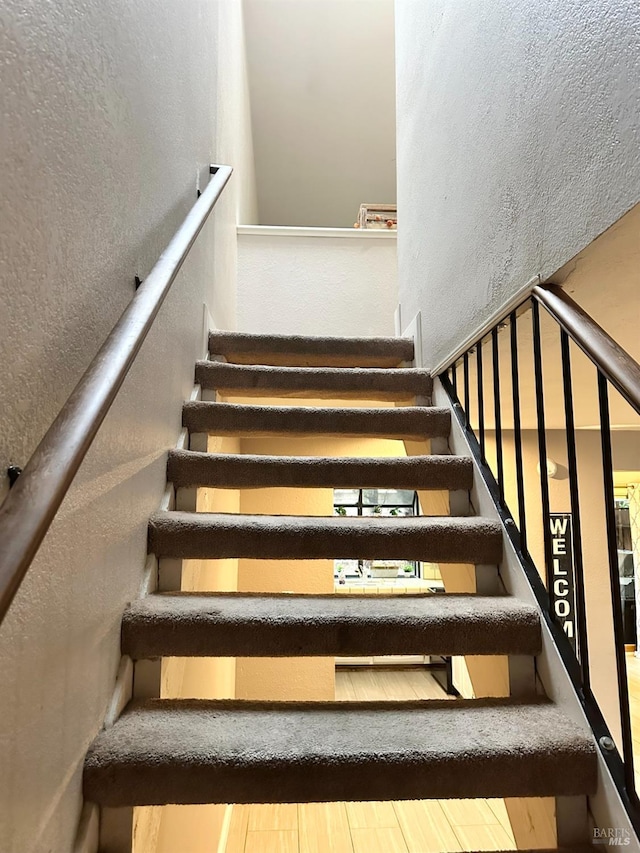 stairway featuring hardwood / wood-style flooring