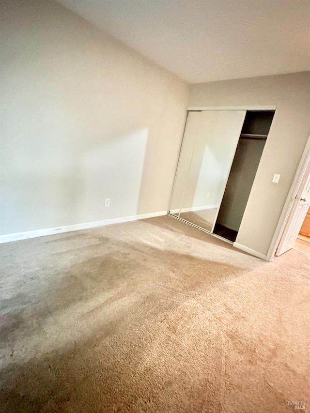 unfurnished bedroom featuring a closet and carpet flooring