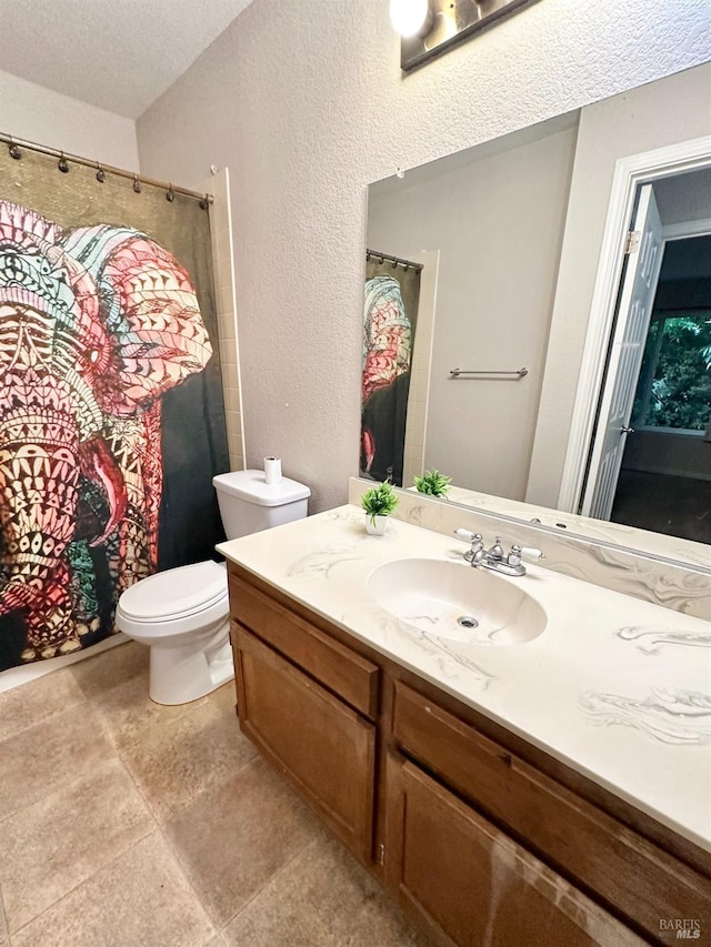 bathroom with toilet, a textured ceiling, and vanity