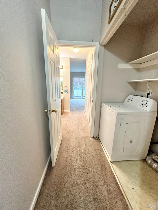 laundry room featuring washer / clothes dryer and light colored carpet