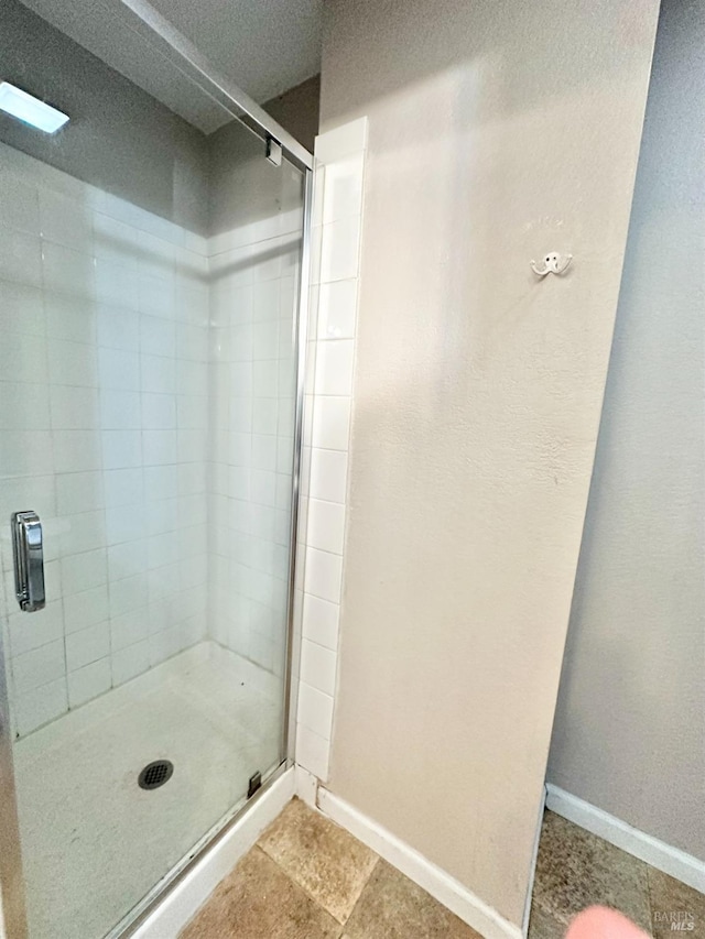 bathroom with a shower with shower door