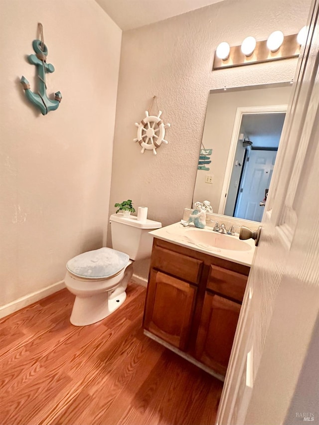 bathroom featuring hardwood / wood-style floors, toilet, and vanity