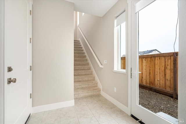 stairway with tile patterned floors