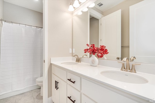 full bathroom with tile patterned flooring, vanity, toilet, and shower / bath combo