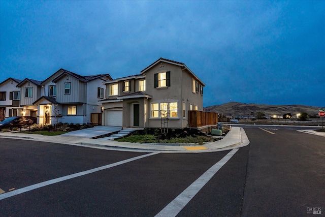 view of front facade with a mountain view and a garage