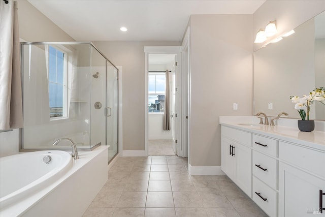 bathroom with tile patterned floors, vanity, and shower with separate bathtub