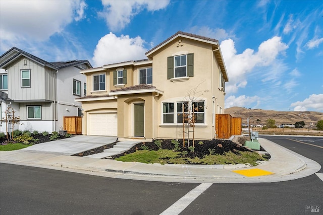 view of front facade with a mountain view and a garage