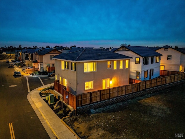 view of back house at dusk