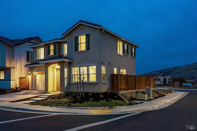 view of front facade with a mountain view and a garage