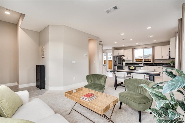 tiled living room featuring sink