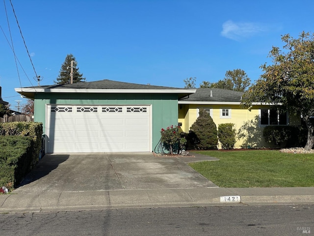 single story home with a garage and a front lawn