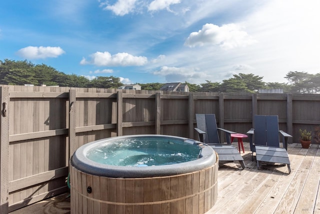 wooden deck with a hot tub