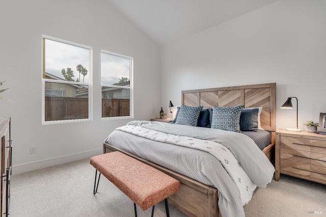 bedroom with carpet floors and vaulted ceiling