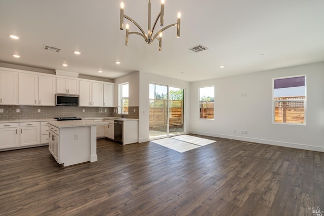 kitchen featuring a center island, white cabinets, stainless steel appliances, and dark hardwood / wood-style floors