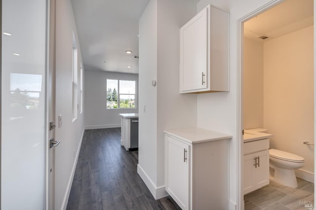 corridor featuring dark hardwood / wood-style floors