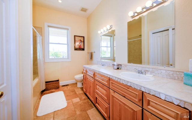 full bathroom featuring a healthy amount of sunlight, toilet, shower / tub combo, and vanity