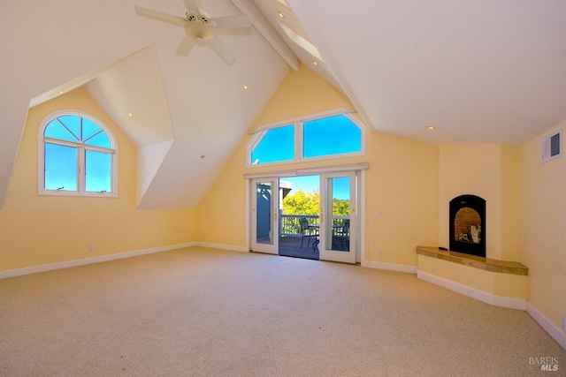 unfurnished living room with ceiling fan, light colored carpet, beam ceiling, and high vaulted ceiling