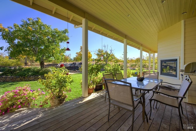 wooden deck featuring a yard