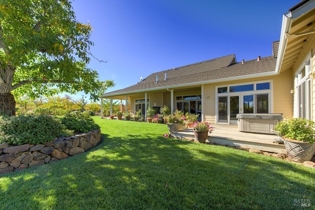 view of yard with a hot tub and a deck