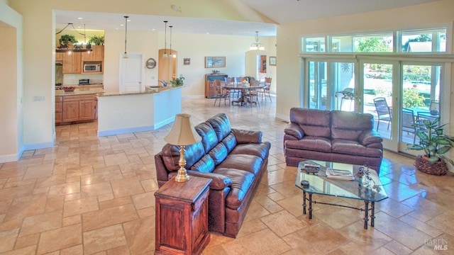 living room with sink and high vaulted ceiling