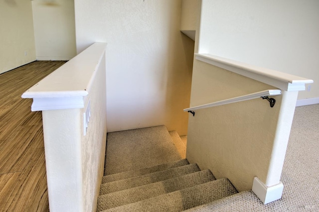 stairway featuring hardwood / wood-style floors