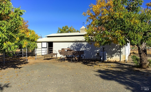 view of side of home featuring an outbuilding