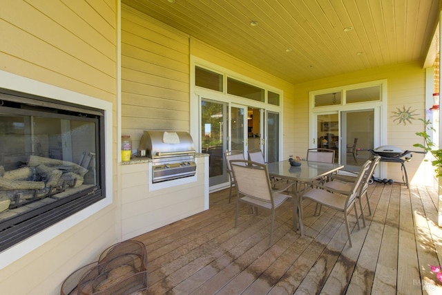 wooden deck featuring an outdoor kitchen and area for grilling