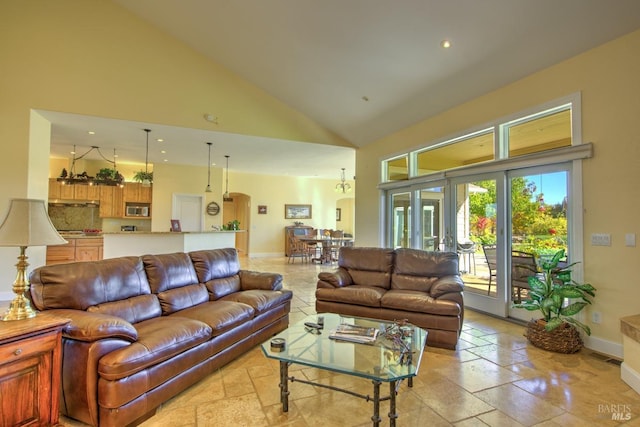 living room with high vaulted ceiling