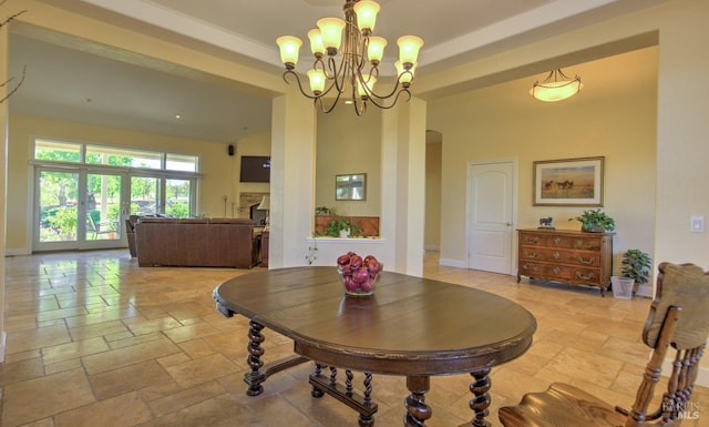 dining space featuring a high ceiling and an inviting chandelier