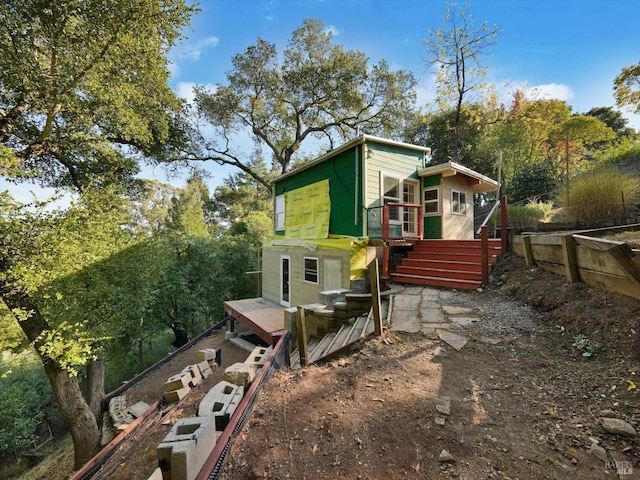 view of property exterior featuring a wooden deck