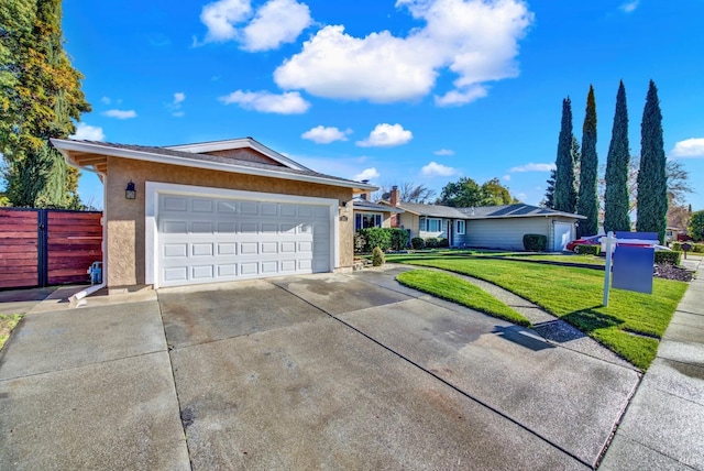 ranch-style home featuring a front lawn and a garage