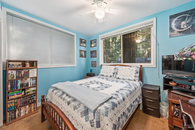 bedroom with a ceiling fan and carpet flooring