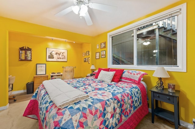 carpeted bedroom featuring baseboards and a ceiling fan