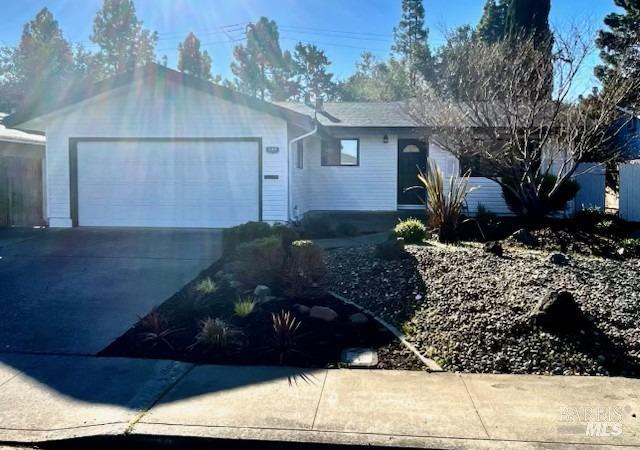 ranch-style home featuring driveway and an attached garage