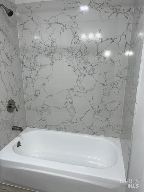 full bath featuring bathing tub / shower combination