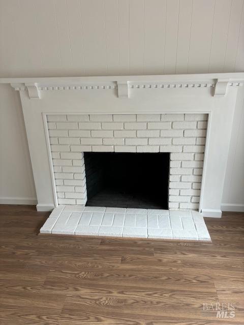 room details with a fireplace and hardwood / wood-style flooring