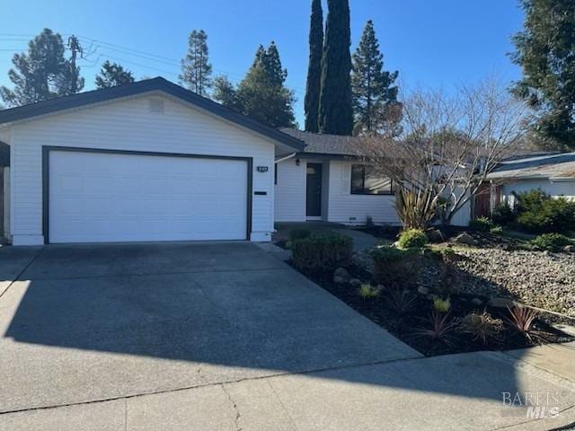 single story home with concrete driveway and a garage