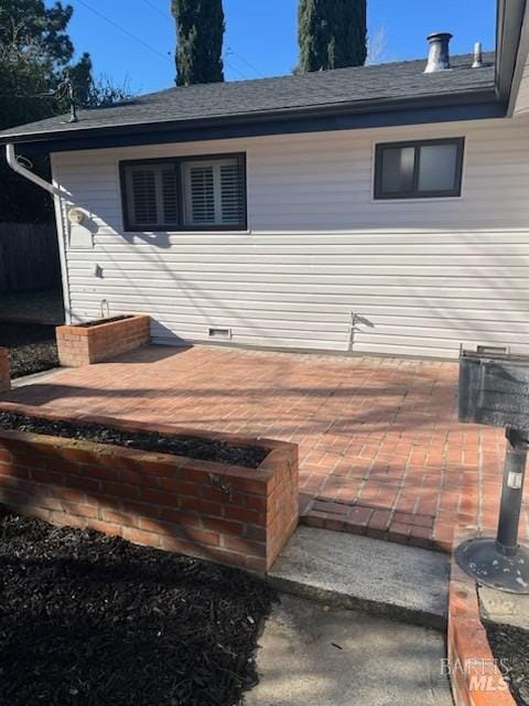 exterior space with roof with shingles