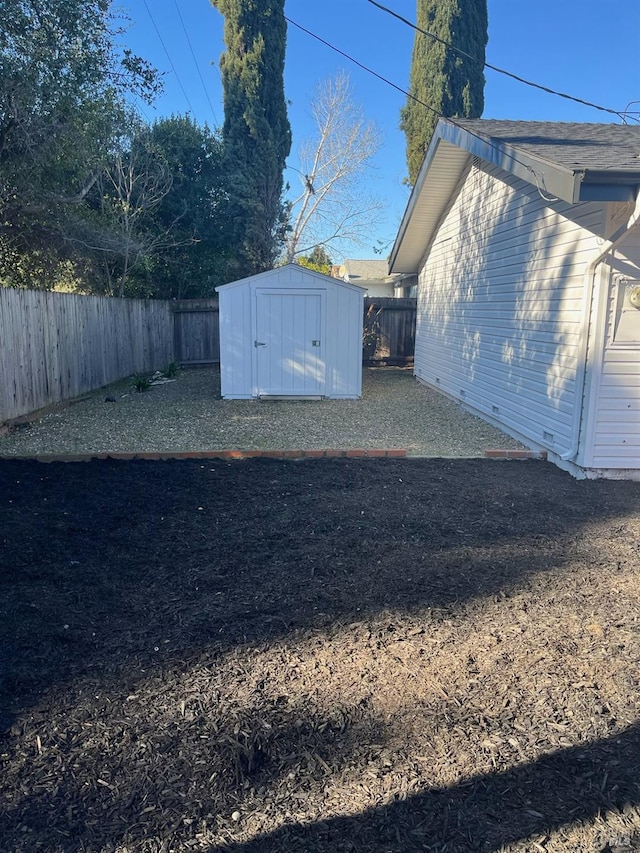 exterior space featuring a storage shed, an outdoor structure, and a fenced backyard
