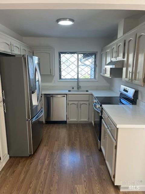 kitchen featuring dark wood-type flooring, sink, white cabinets, and appliances with stainless steel finishes