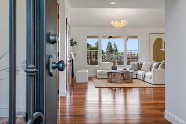 living room featuring a notable chandelier and wood-type flooring