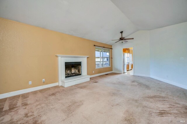 unfurnished living room featuring light colored carpet, ceiling fan, and lofted ceiling