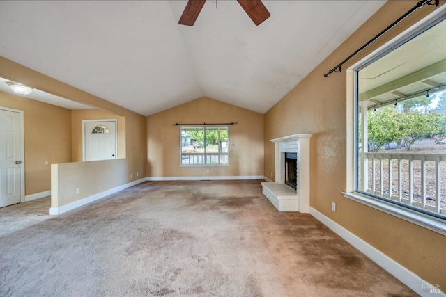 unfurnished living room featuring carpet flooring, ceiling fan, and vaulted ceiling