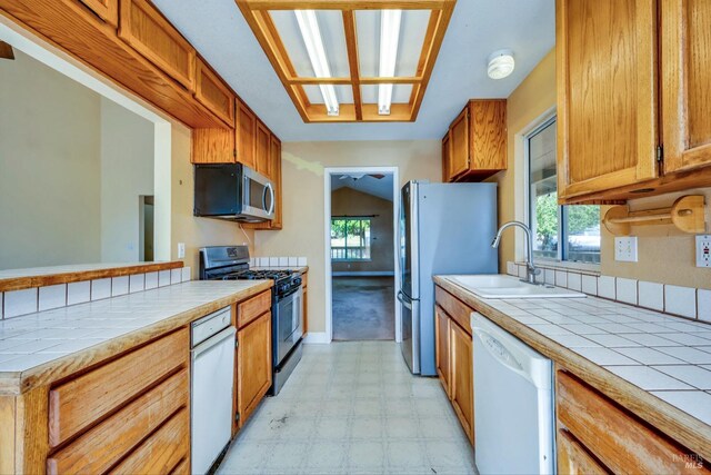 kitchen with tile countertops, plenty of natural light, and appliances with stainless steel finishes