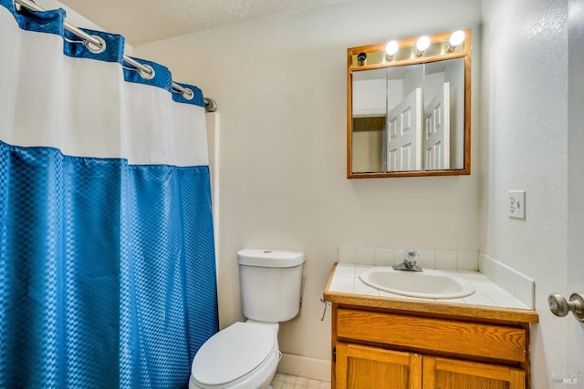 bathroom with tile patterned flooring, a textured ceiling, toilet, vanity, and a shower with shower curtain