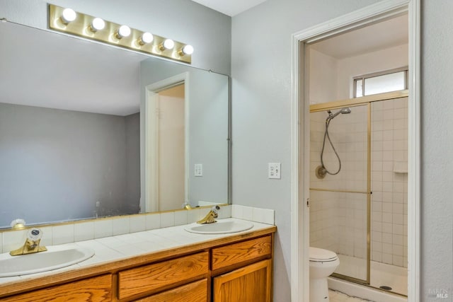 19207 Ravenhill Rd, Hidden Valley Lake, CA 95467 - bathroom featuring a sink, a shower stall, toilet, and double vanity