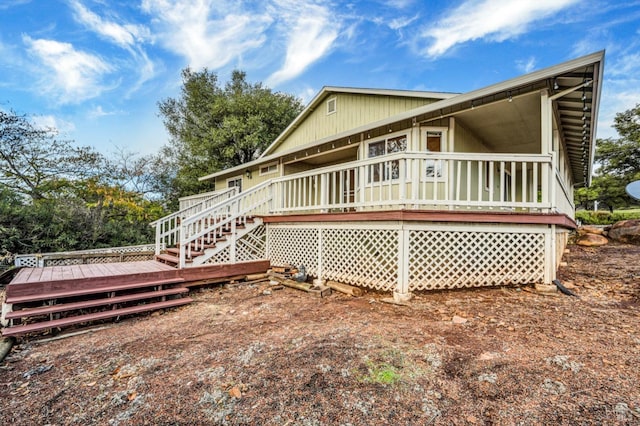 back of house with a wooden deck