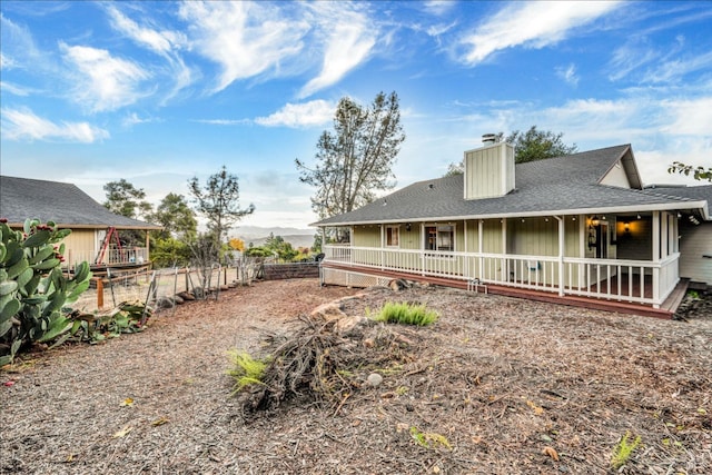 19207 Ravenhill Rd, Hidden Valley Lake, CA 95467 - rear view of property featuring roof with shingles, a chimney, and fence