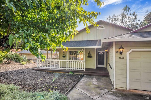 view of exterior entry featuring covered porch