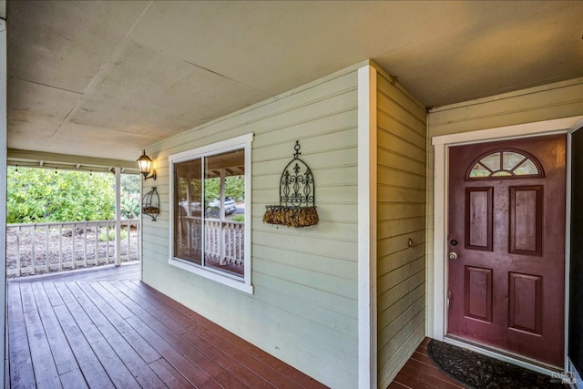 view of exterior entry featuring a porch